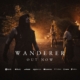 Promotional album cover for Wanderer: a hooded warrior stands by a campfire at night with others in the background; text reads 'WANDERER' and 'OUT NOW'.